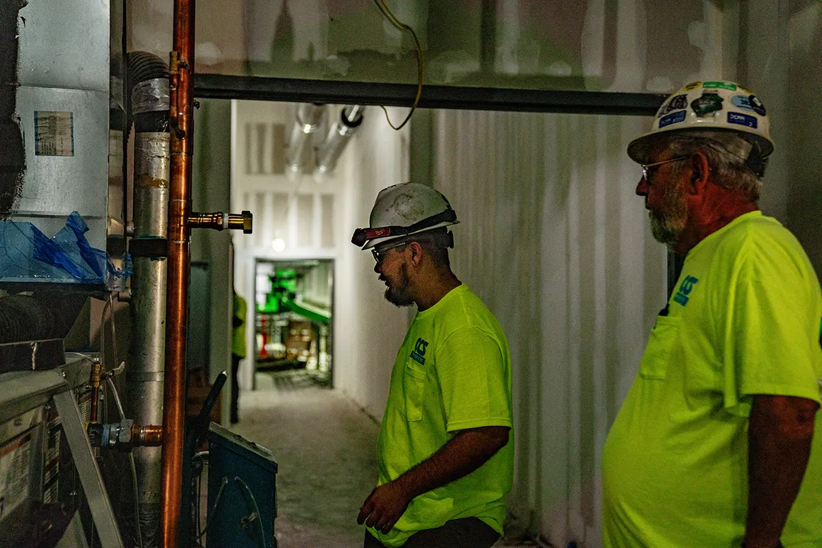 CCS crew members at work in a mechanical space