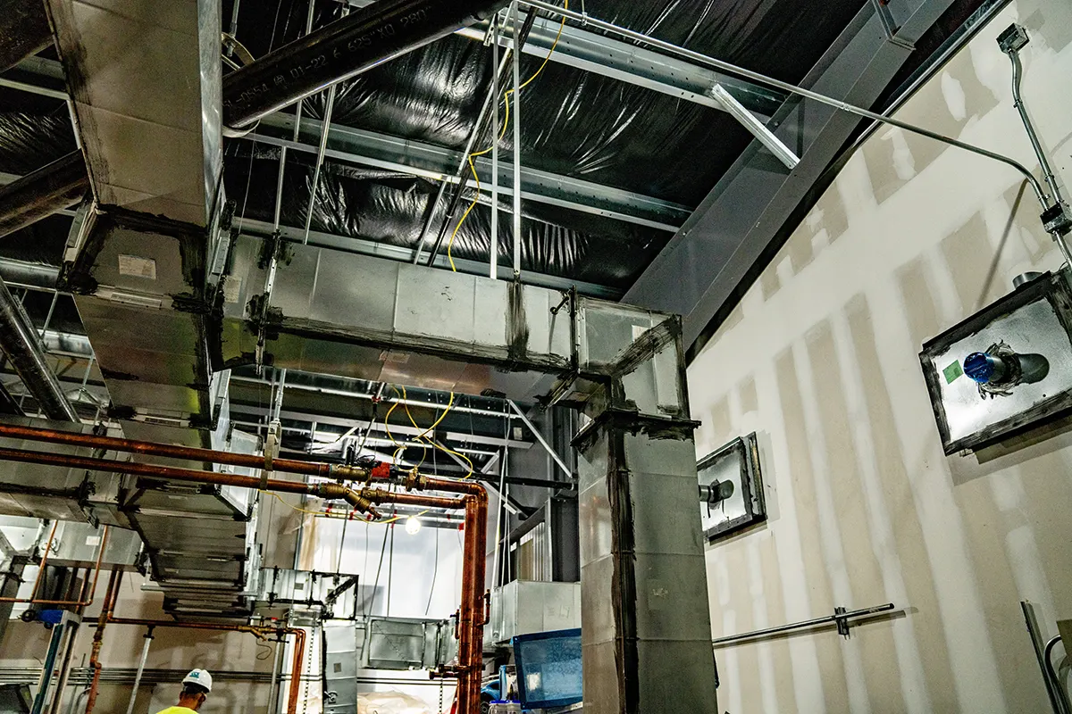 Ductwork and copper piping along an interior wall