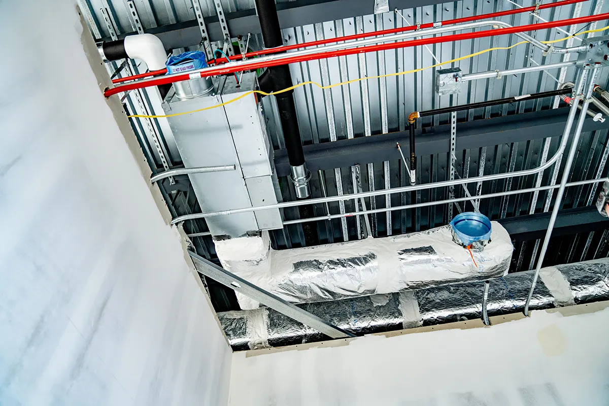 Duct, piping and conduit overhead inside a building